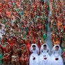 Indian brides sit together for a group photograph during a mass wedding in Surat, India, Dec. 23, 2018. 