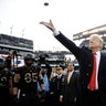 President Donald Trump tosses the coin before the Army-Navy NCAA college football game in Philadelphia, Dec. 8, 2018. 