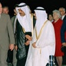 In this Nov. 21, 1990 file photo, President George H.W. Bush is greeted by King Fahd as he arrives in Saudi Arabia. At right is first lady Barbara Bush. At center is an interpreter. 