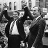 In this Nov. 3, 1980 file photo, former President Gerald Ford lends his support to Republican presidential candidate Ronald Reagan and his running mate George H.W. Bush, in Peoria, Ill. 