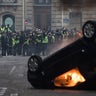 Car lit of fire during clashes between police and demonstrators, during demonstration of the "Yellow vests", in Paris, France, on December 8th 2018.