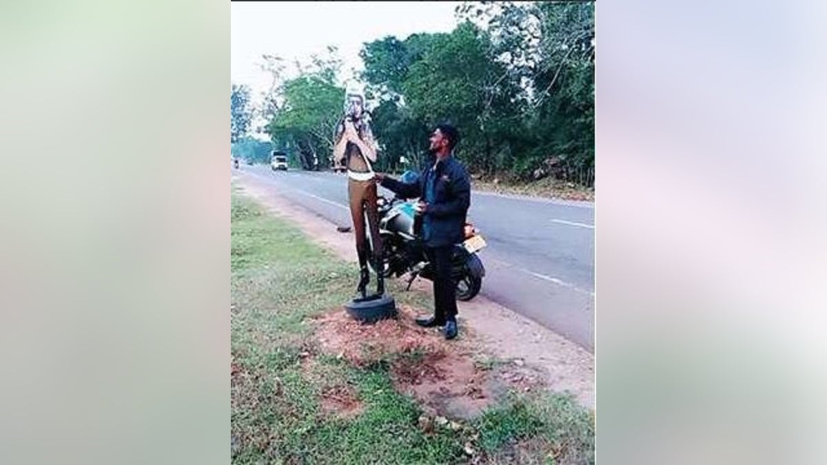 Two men face charges after allegedly pretending to bribe a cardboard cutout of a traffic cop in Sri Lanka. (Vavuniya Police)