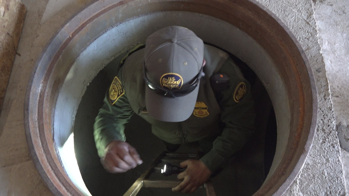 A Border Patrol agent demonstrates climbing into and out of the mock tunnels used for training at the Border Patrol Tucson Sector Nogales Station.