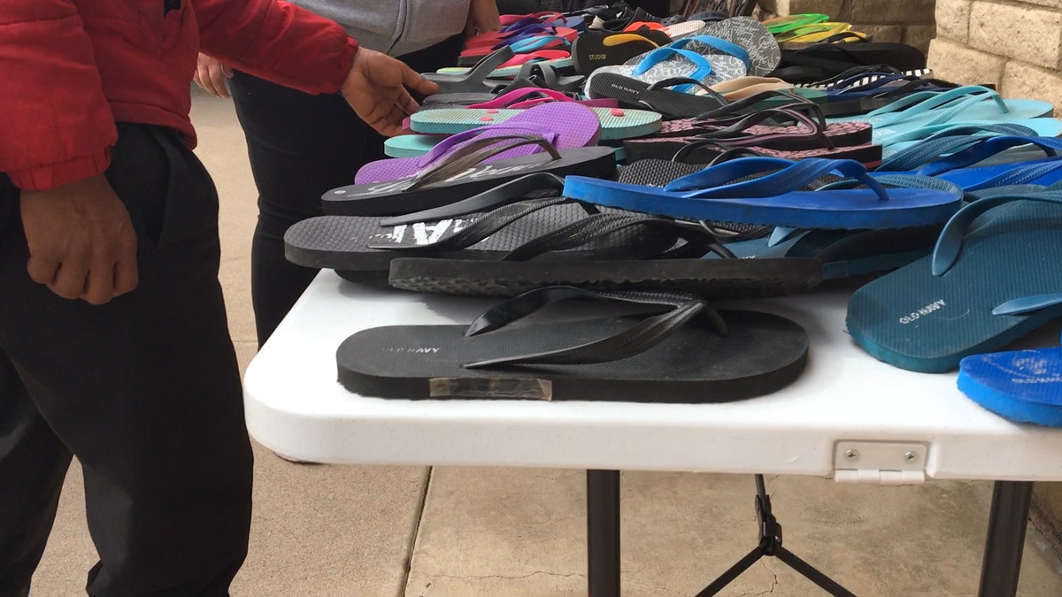 A migrant chooses from a selection of donated shoes at Longview Community Church