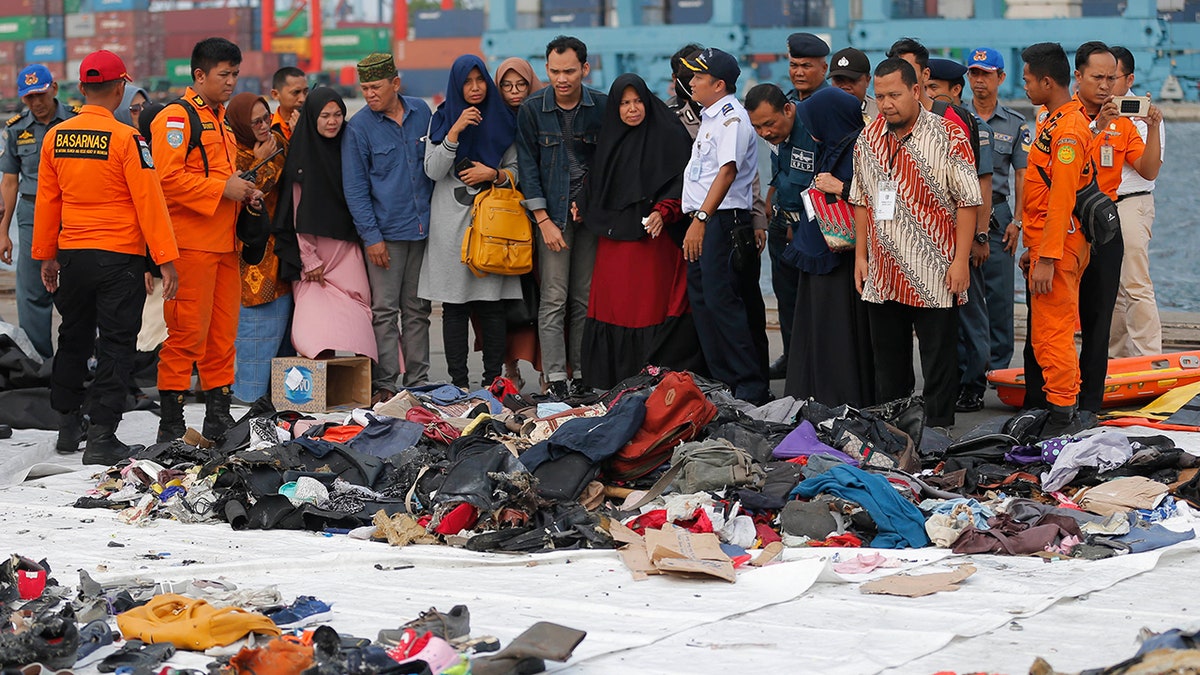 In the days following the crash, distinct similarities have been found between the Ethiopian Airlines crash and that of a Lion Air flight in October 2018, which left 189 people dead. Both planes with 737 MAXs and used the MCAS safety system. Mourners are pictured here remembering loved ones at the location where the Lion Air flight is believed to have crashed