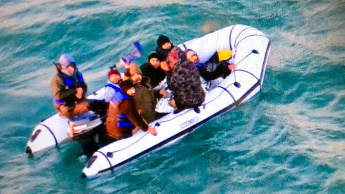 This image provided by the Marine Nationale (French Navy) shows migrants aboard a rubber boat after being intercepted by French authorities, off the port of Calais, northern France, Tuesday, Dec. 25, 2018. (Marine Nationale via AP)