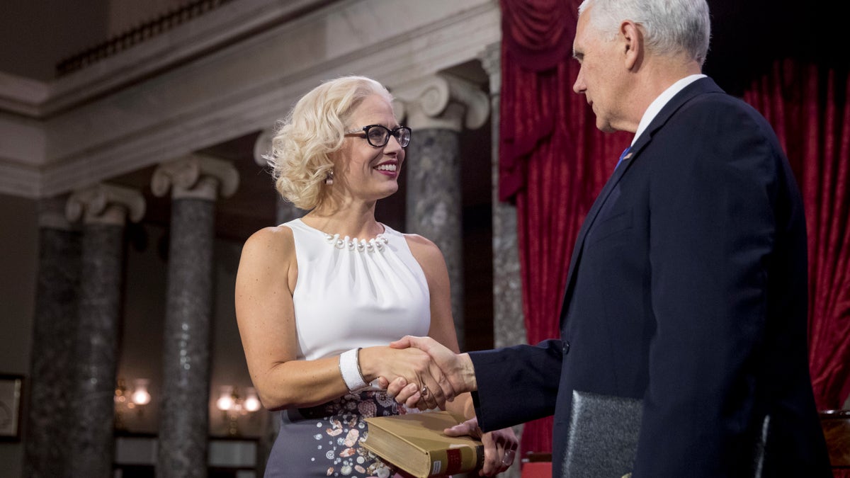 Vice President Mike Pence administers the Senate oath of office to Sen. Kyrsten Sinema, D-Ariz., during a mock swearing in ceremony in the Old Senate Chamber on Capitol Hill in Washington, Thursday, Jan. 3, 2019, as the 116th Congress begins.