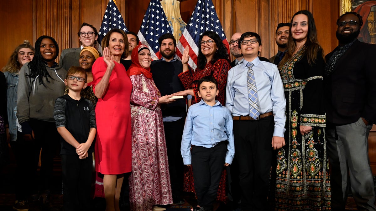 House Speaker Nancy Pelosi of Calif., poses during a ceremonial swearing-in with Rep. Rashida Tlaib, D-Mich., sixth from right, on Capitol Hill in Washington, Thursday, Jan. 3, 2019, during the opening session of the 116th Congress. (AP Photo/Susan Walsh)