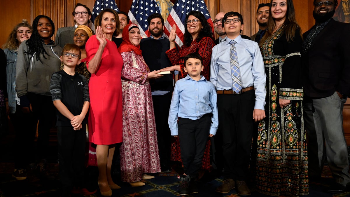 House Speaker Nancy Pelosi of Calif., poses during a ceremonial swearing-in with Rep. Rashida Tlaib, D-Mich., sixth from right, on Capitol Hill in Washington, Thursday, Jan. 3, 2019, during the opening session of the 116th Congress. (AP Photo/Susan Walsh)