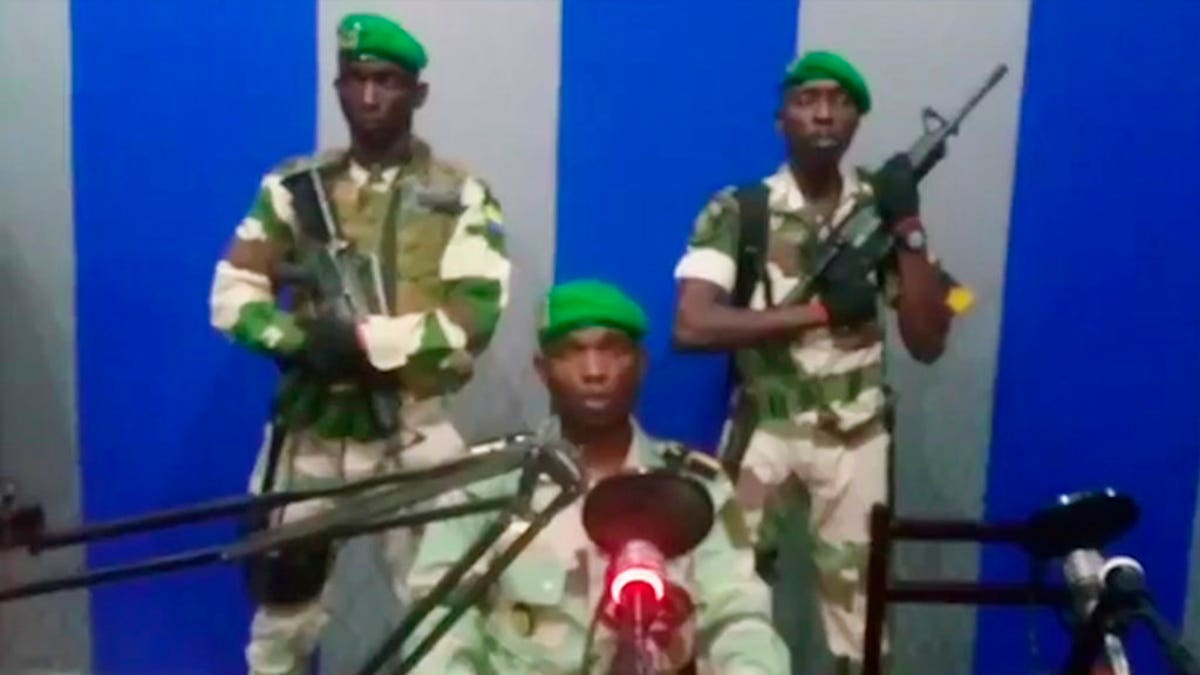 A soldier who identified himself as Lt. Obiang Ondo Kelly, commander of the Republican Guard, reads a statement on state television broadcast from Libreville, saying the military has seized control of the government. (