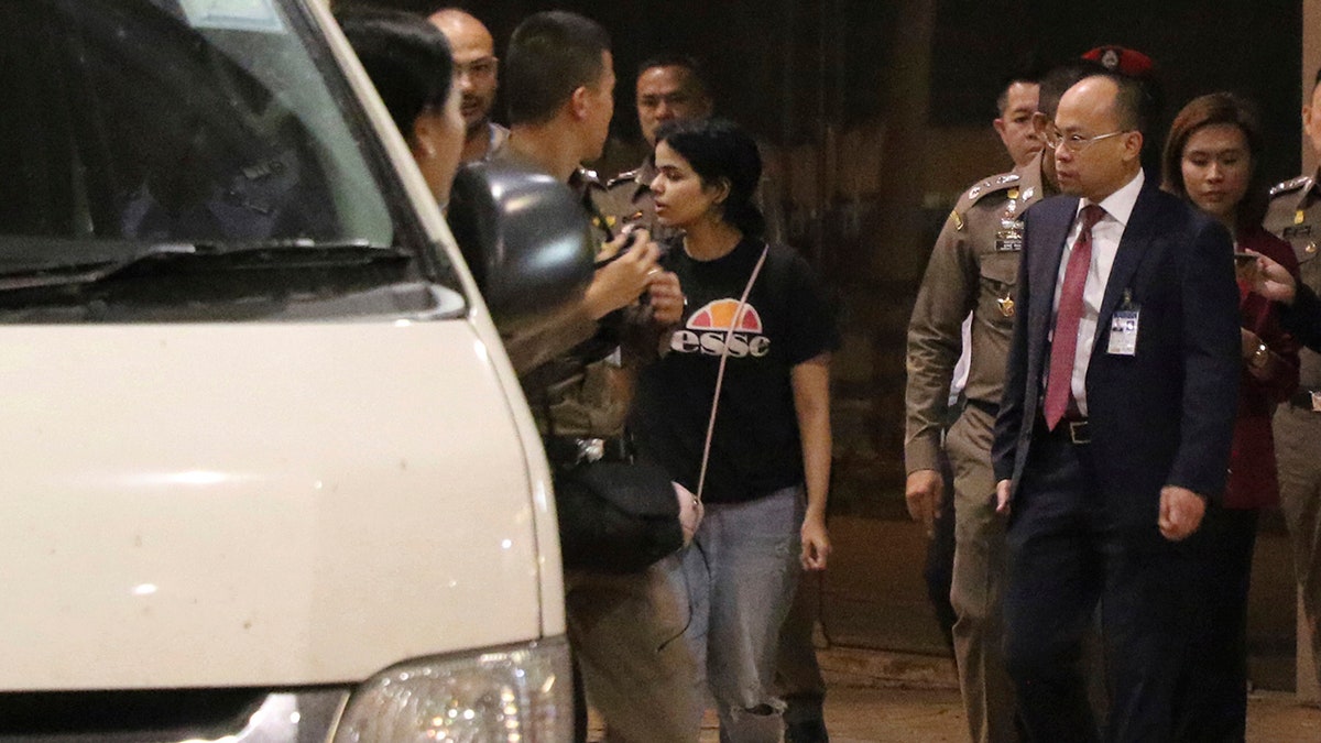 Rahaf Mohammed Alqunun, who says she is fleeing abuse by her family and wants asylum in Australia, leaves the Suvarnabhumi Airport in Bangkok Monday. (AP Photo)
