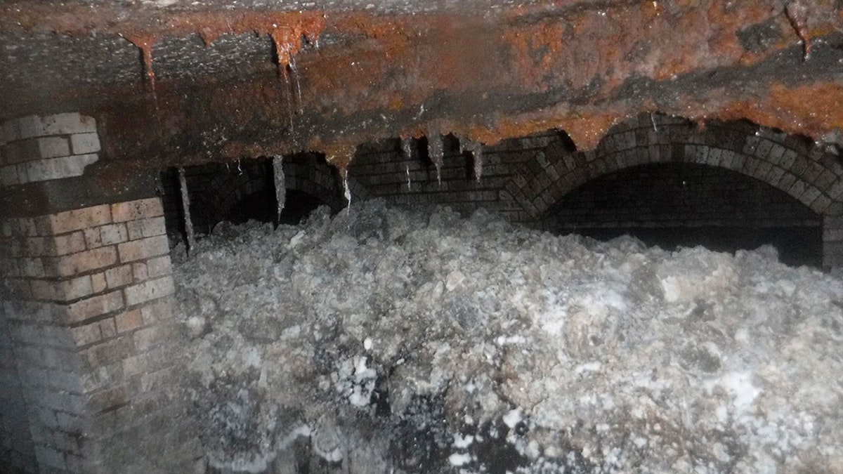 In this photo released Tuesday Jan. 8, 2019, by Britain's South West Water company, showing part of a "fatberg", a mass of hardened fat, oil and baby wipes, measuring some 64 meters (210 feet) long, in the town of Sidmouth, England. The fatberg is blocking a sewer in the southwestern English town, and will take a sewer team around eight weeks to dissect and dispose of the obstruction. (South West Water via AP)