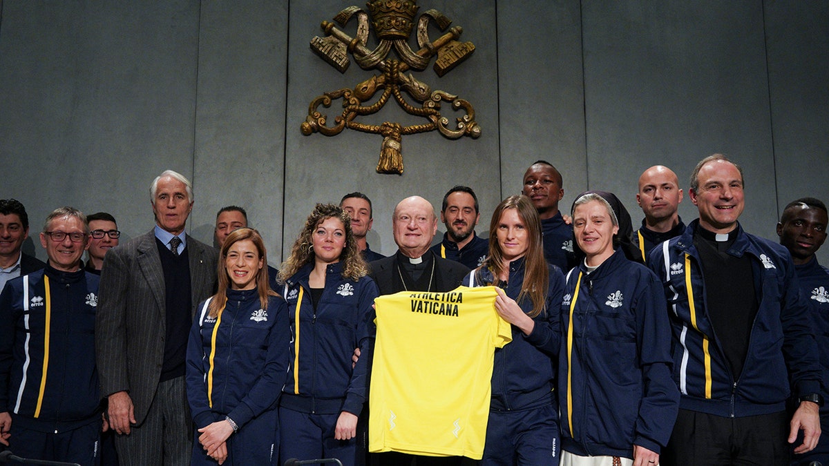 From left, CONI Italian Olympic Committee President Giovanni Malago', Cardinal Gianfranco Ravasi, President of the Pontifical Council for Culture and Melichor Jose' Sanchez de Toca y Alameda, right, pose for photos at the end of a press conference, at the Vatican.