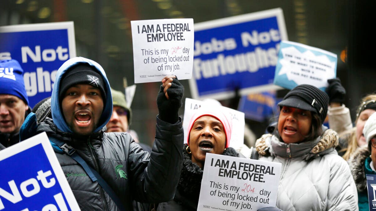 Government workers rally against the partial government shutdown at Federal Plaza, Thursday, Jan. 10, 2019, in Chicago. (AP Photo/Kiichiro Sato)