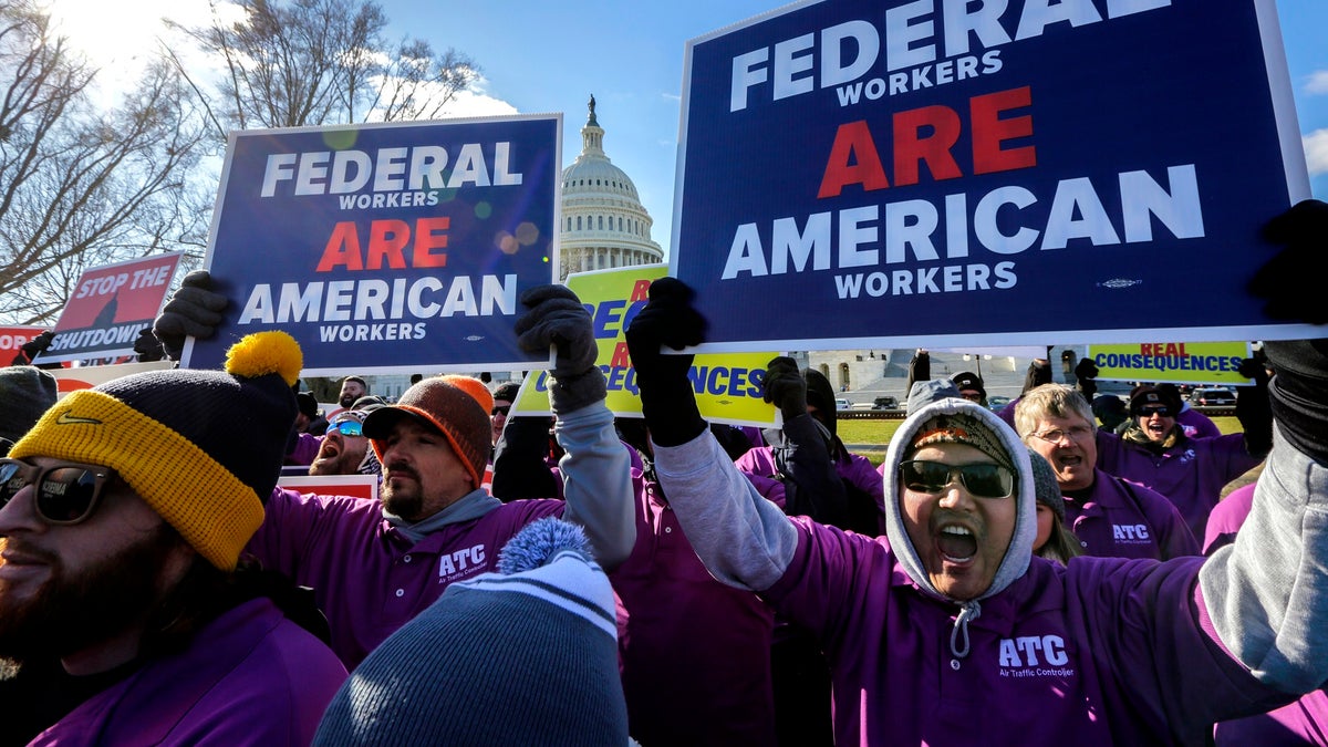 On the 20th day of a partial government shutdown, federal employees rally at the Capitol to protest the impasse between Congress and President Donald Trump over his demand to fund a U.S.-Mexico border wall, in Washington, Thursday, Jan. 10, 2019. (AP Photo/J. Scott Applewhite)