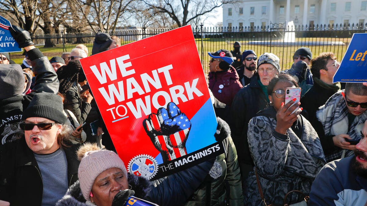 Union members and other federal employees stop in front of the White House in Washington during a rally to call for an end to the partial government shutdown, Thursday, Jan. 10, 2019. (AP Photo/Pablo Martinez Monsivais)