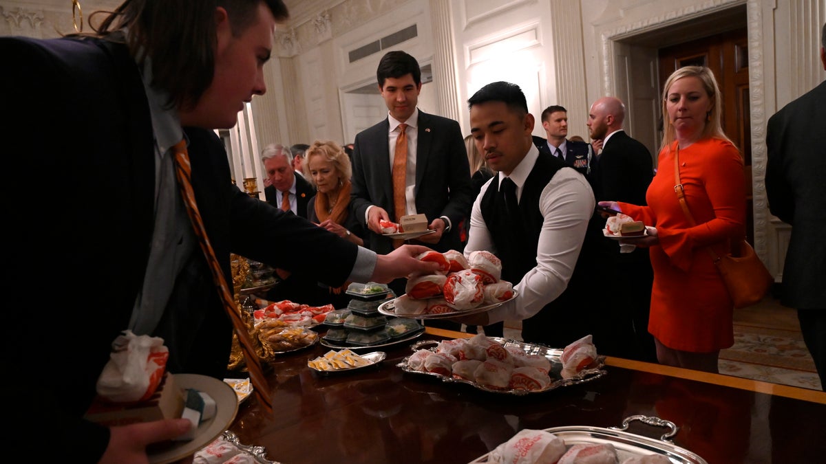 Guests attending a reception for the Clemson Tigers grab fast food sandwiches in the State Dining Room of the White House in Washington, Monday, Jan. 14, 2019. (AP Photo/Susan Walsh)