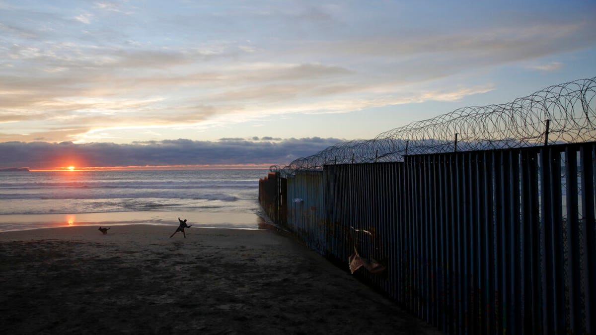 The border wall topped with razor wire in Tijuana, Mexico, earlier this month. (AP Photo/Gregory Bull, File)