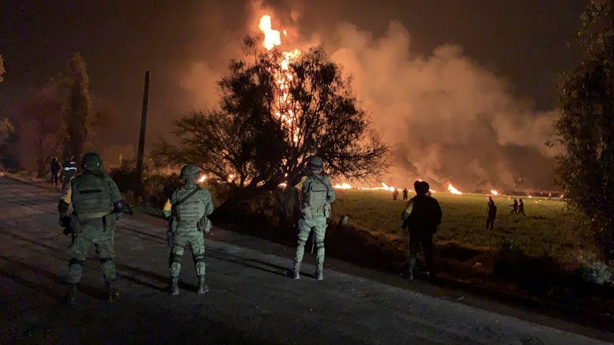 Mexican soldiers guard the area near an oil pipeline explosion in Tlahuelilpan, Hidalgo state, Mexico, Friday, Jan. 18, 2019. 