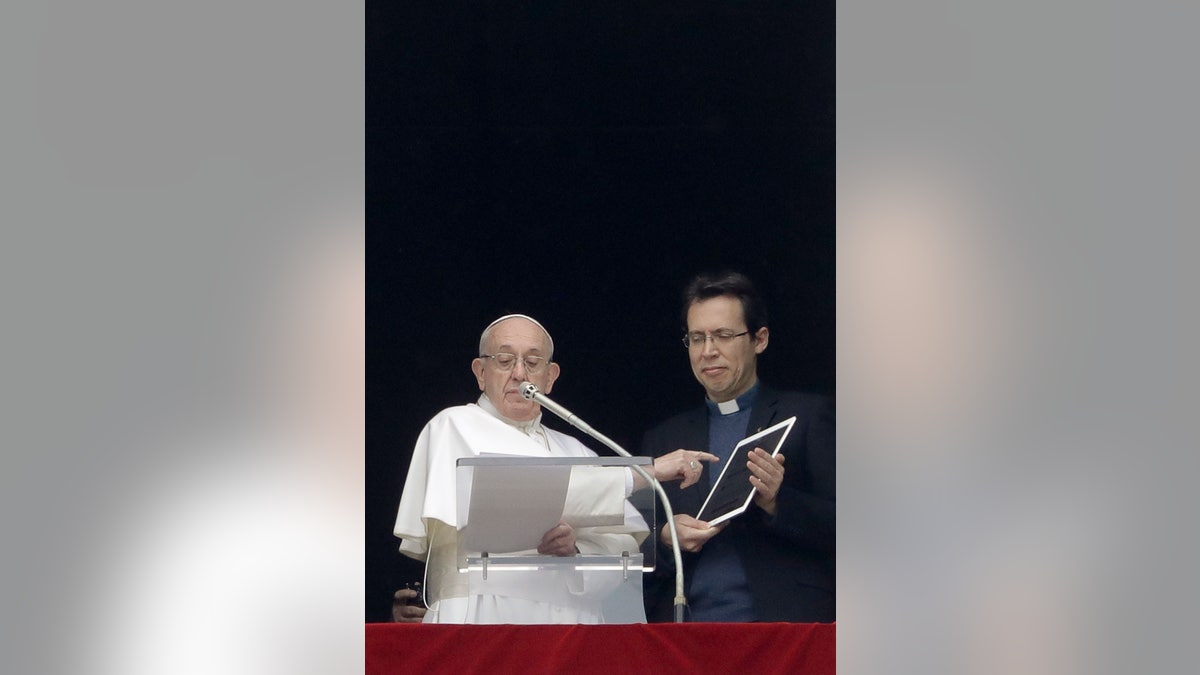 Pope Francis points at a tablet as he unveils his own user profile in Click To Pray, the official app of the Pope's Worldwide Prayer Networ. (AP Photo/Andrew Medichini)