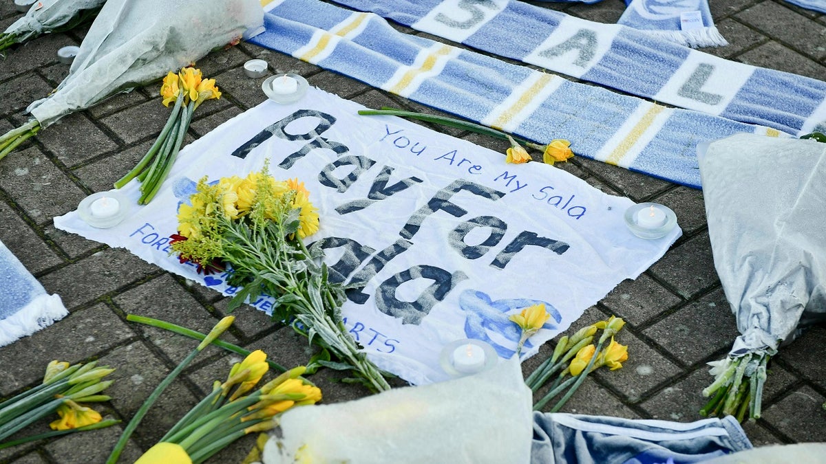 Flowers and tributes are placed outside Cardiff City Football Club, Wales, Wednesday Jan. 23, 2019, after a plane with new signing Emiliano Sala on board went missing over the English Channel.