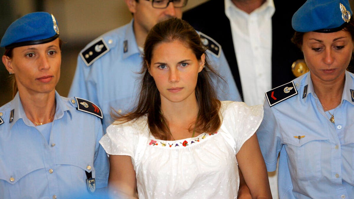Amanda Knox escorted by Italian police officers in 2015