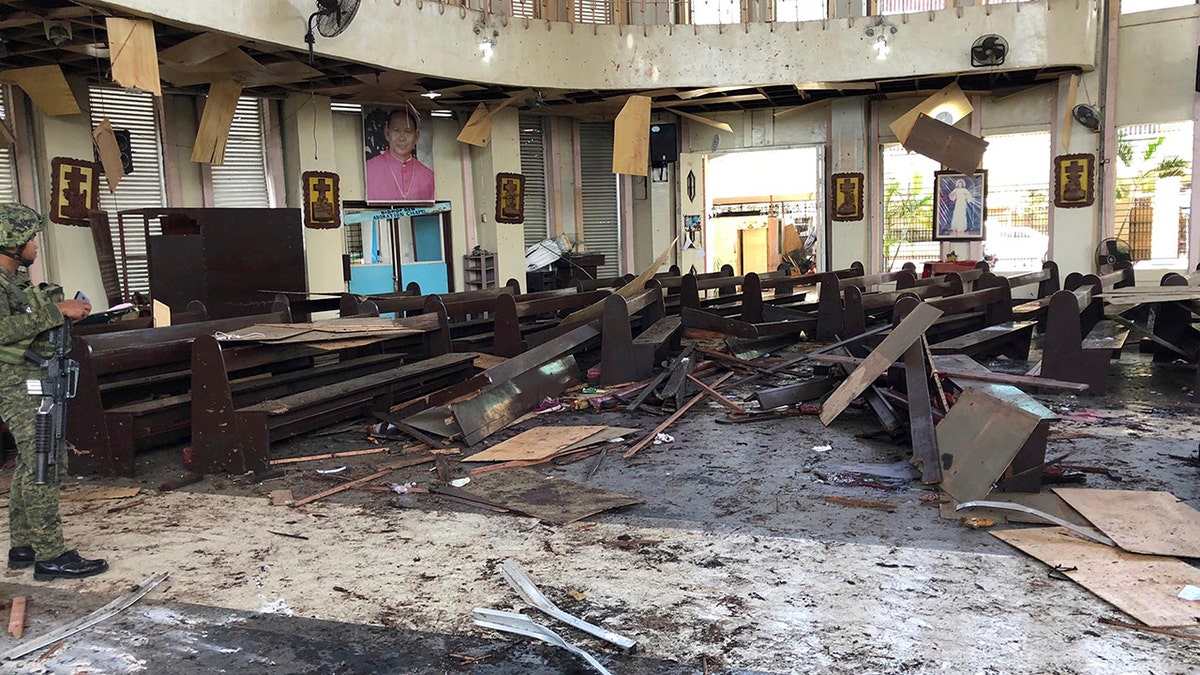 The Philippine government says it will "pursue to the ends of the earth the ruthless perpetrators" behind bomb attacks that killed over a dozen people and wounded many more during a Sunday Mass at a cathedral on the restive southern island. (WESMINCOM Armed Forces of the Philippines Via AP)