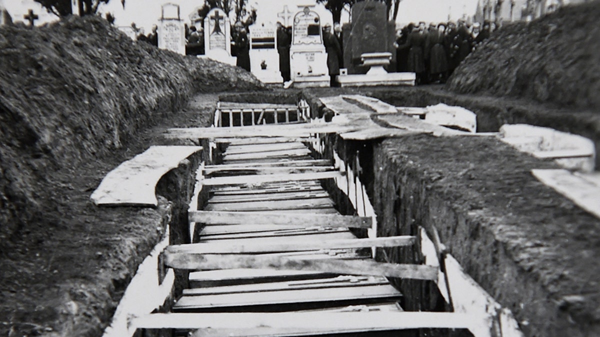 A photo taken on Decembre 5, 2018 in Villeneuve-d'Ascq, northern France, shows a reproduction of a photograph showing coffins after the massacre of Ascq in 1944 during WWII. 