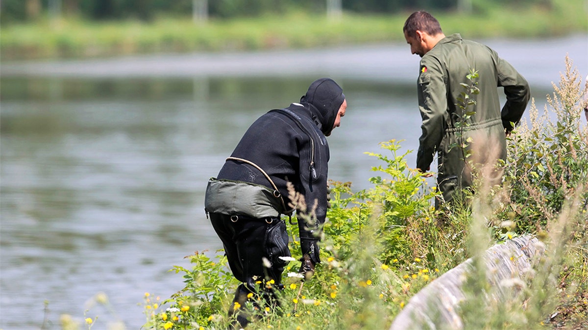 A diver gets out of the canal in Ronquieres, some 20 miles south of Brussels on August 3, 2010 during a search for evidence in the "Brabant's killers" case. 