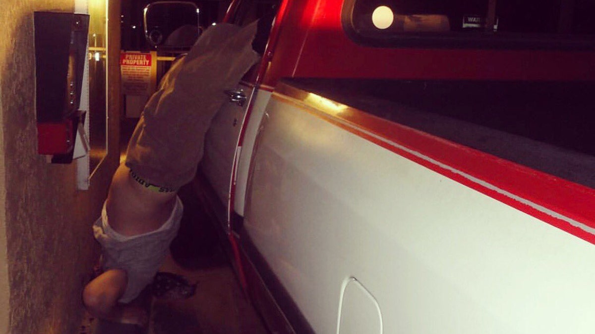 A man was arrested after fleeing a hit-and-run and getting his foot stuck on the steering wheel, police said.