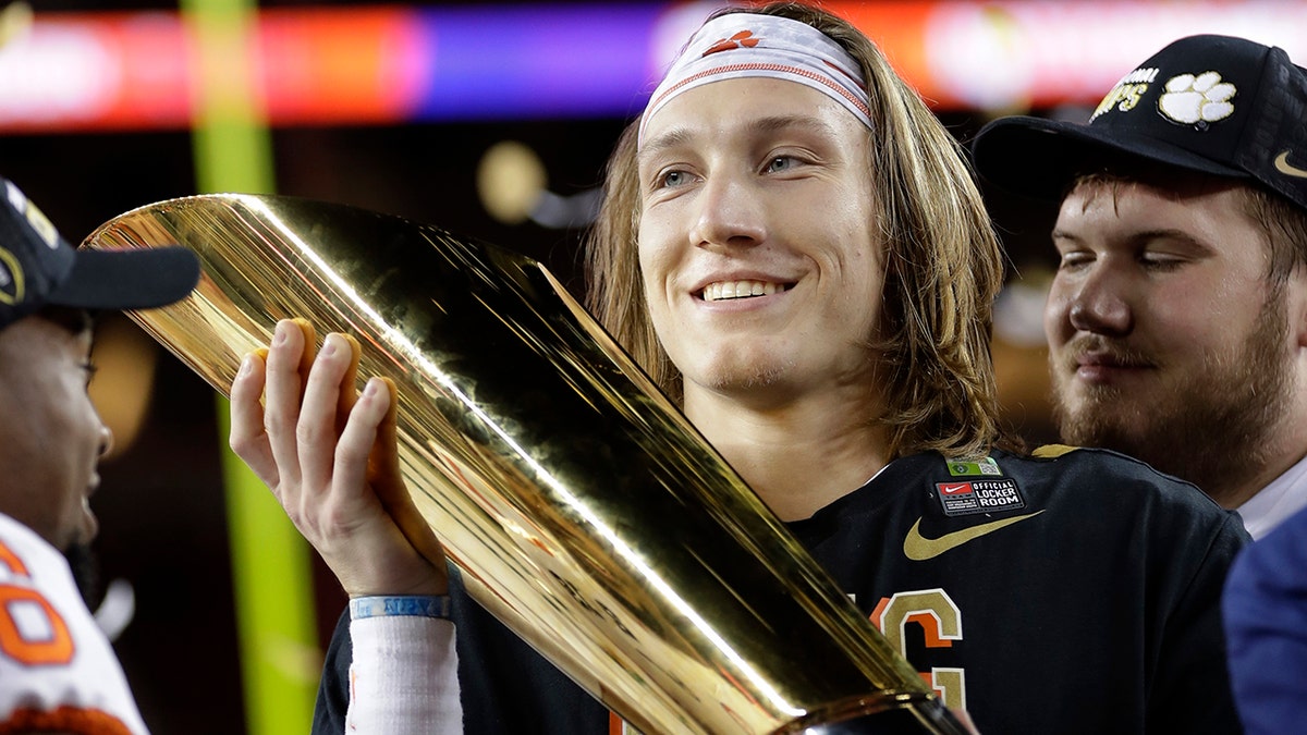 Clemson's Trevor Lawrence holds the trophy after the NCAA college football playoff championship game against Alabama, Monday, Jan. 7, 2019, in Santa Clara, Calif. Clemson beat Alabama 44-16.
