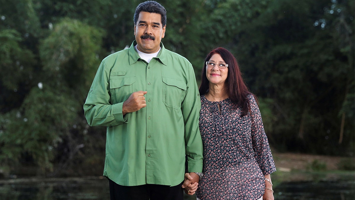 Venezuela's President Nicolas Maduro (L) and his wife and deputy of Venezuela's United Socialist Party (PSUV) pose for a photo during the recording of a government Christmas message in Caracas, Venezuela December 20, 2016. 