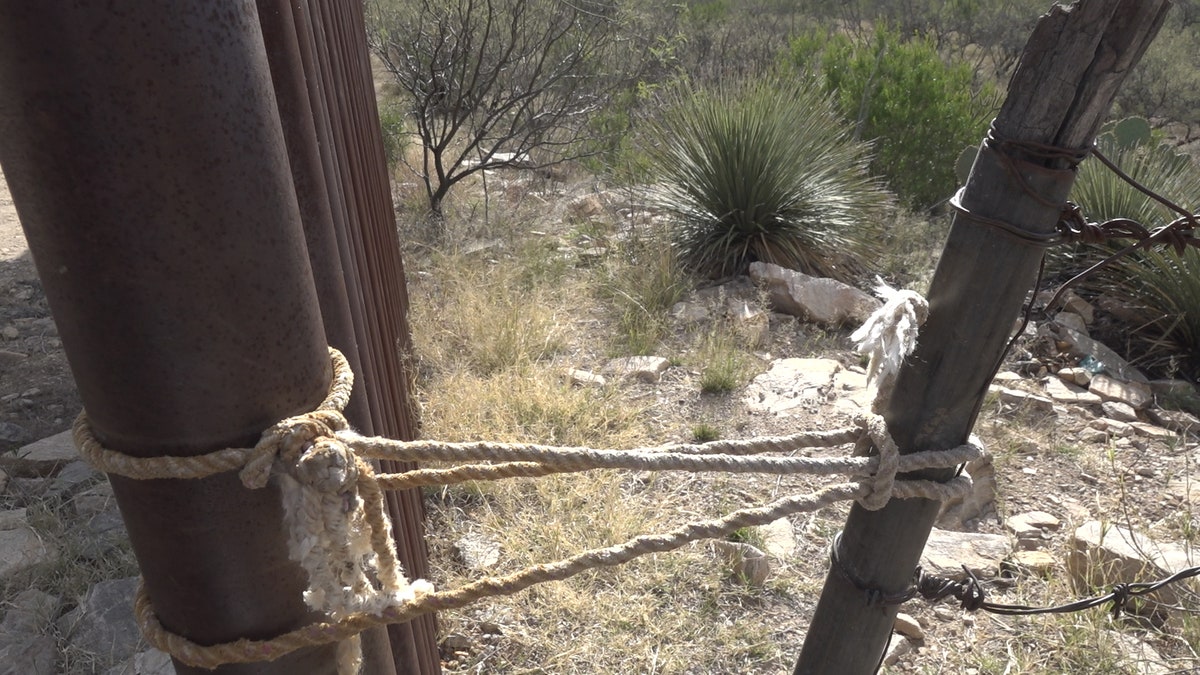 For this particular part of the tour, they stopped after that mile-and-a-half—only to see vast, rugged landscape and another fence made of barbed wire, sticks, and rope—with just a slipknot connecting the barbed wire to the steel poles where the wall ended.