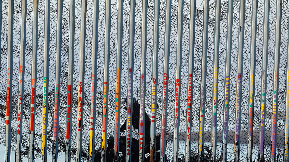 A Border Patrol agent rides a vehicle on the beach in San Diego, earlier this month, in a view through a border barrier from Tijuana, Mexico.?(AP Photo/Gregory Bull)