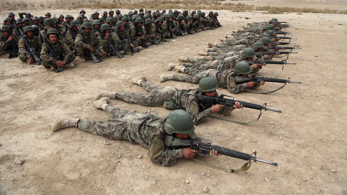 In this Oct. 31, 2018, photo, Afghan National Army (ANA) soldiers carry out an exercise during a live firing at the Afghan Military Academy in Kabul, Afghanistan. 