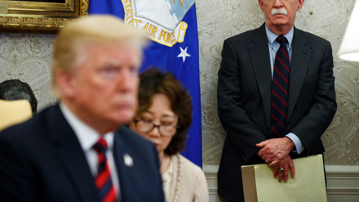 In this May 22, 2018, file photo, U.S. President Donald Trump, left, meets with South Korean President Moon Jae-In in the Oval Office of the White House in Washington, as national security adviser John Bolton, right, watches.