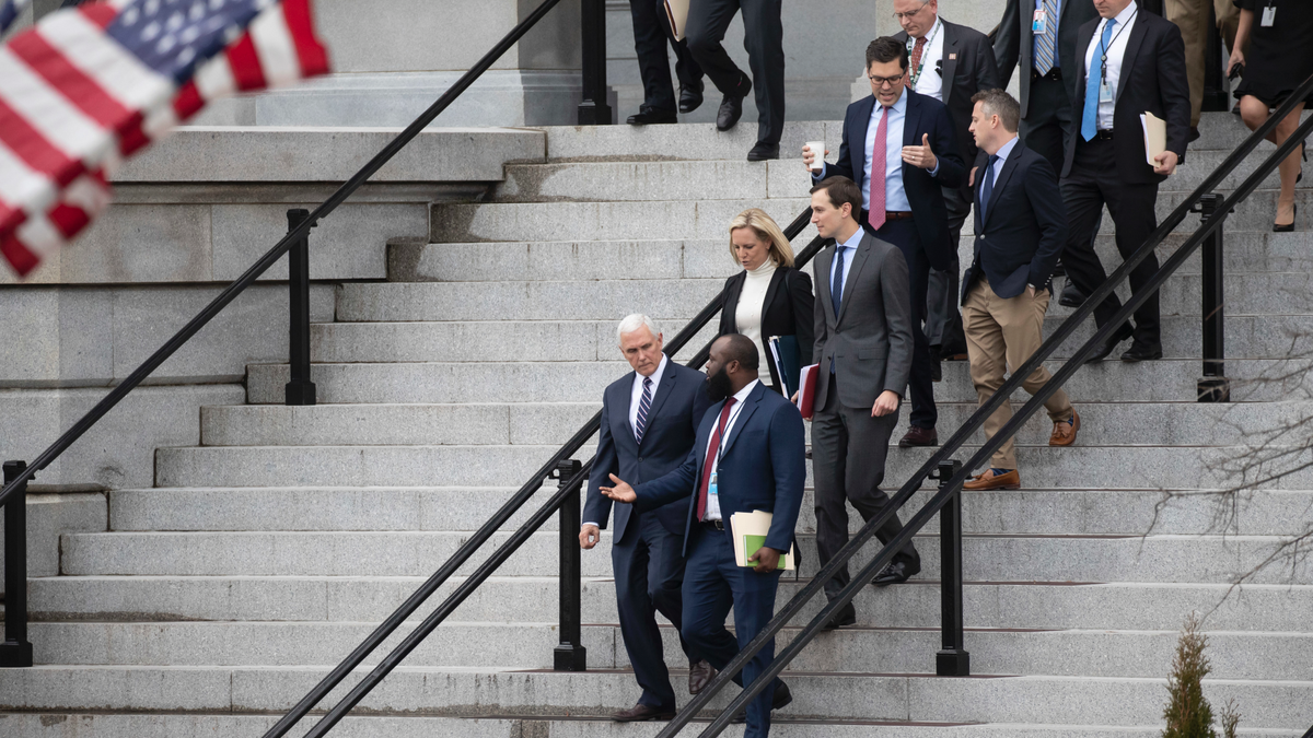Vice President Mike Pence, left, White House legislative affairs aide Ja'Ron Smith, Homeland Security Secretary Kirstjen Nielsen, second row left, White House Senior Adviser Jared Kushner, and others, walk down the steps of the Eisenhower Executive Office building, on the White House complex, after a meeting with staff members of House and Senate leadership, Saturday, Jan. 5, 2019, in Washington. (AP Photo/Alex Brandon)