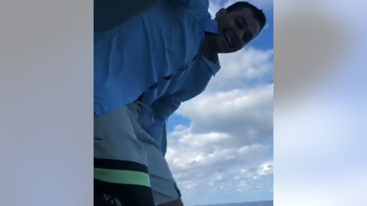 Nick Naydev, 27, shared footage of his friends helping him up on the railing before he jumps from the Symphony of the Seas.