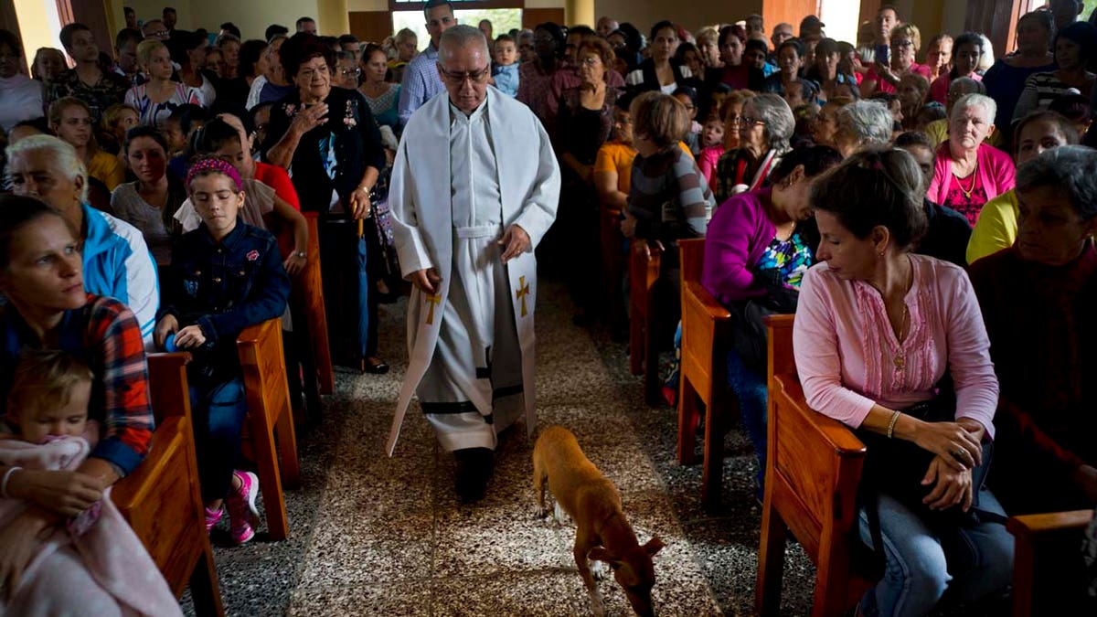 Father Cirilo Castro takes part in the consecration Mass of the Sagrado Corazon de Jesus, or Sacred Heart, Catholic church, in Sandino, Cuba, Saturday, Jan. 26, 2019. (AP Photo/Ramon Espinosa)