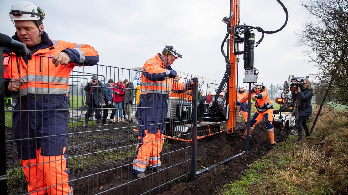 Workers erect a fence along the Denmark Germany border at Padborg, Denmark, Monday Jan. 28, 2019. (Frank Cilius/Ritzau Scanpix via AP)