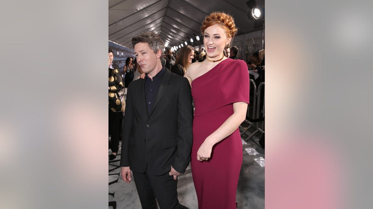 Aidan Gillen and Sophie Turner attend the premiere of HBO's "Game Of Thrones" Season 6 at TCL Chinese Theatre on April 10, 2016 in Hollywood, California.