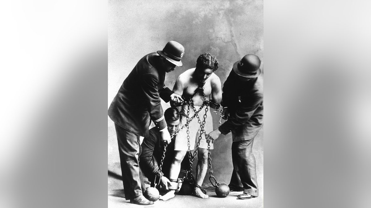 Harry Houdini in chains. — Getty