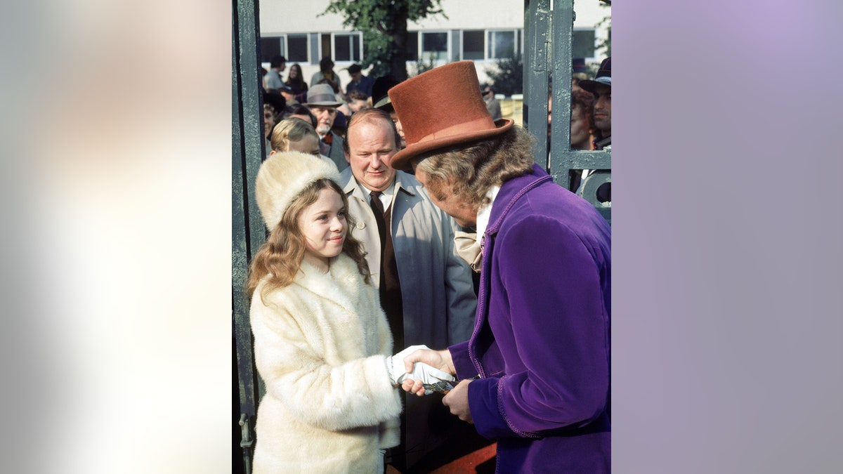 From right to left, actors Gene Wilder as Willy Wonka, Roy Kinnear as Mr. Salt and Julie Dawn Cole as Veruca Salt in the film 'Willy Wonka &amp; the Chocolate Factory.'