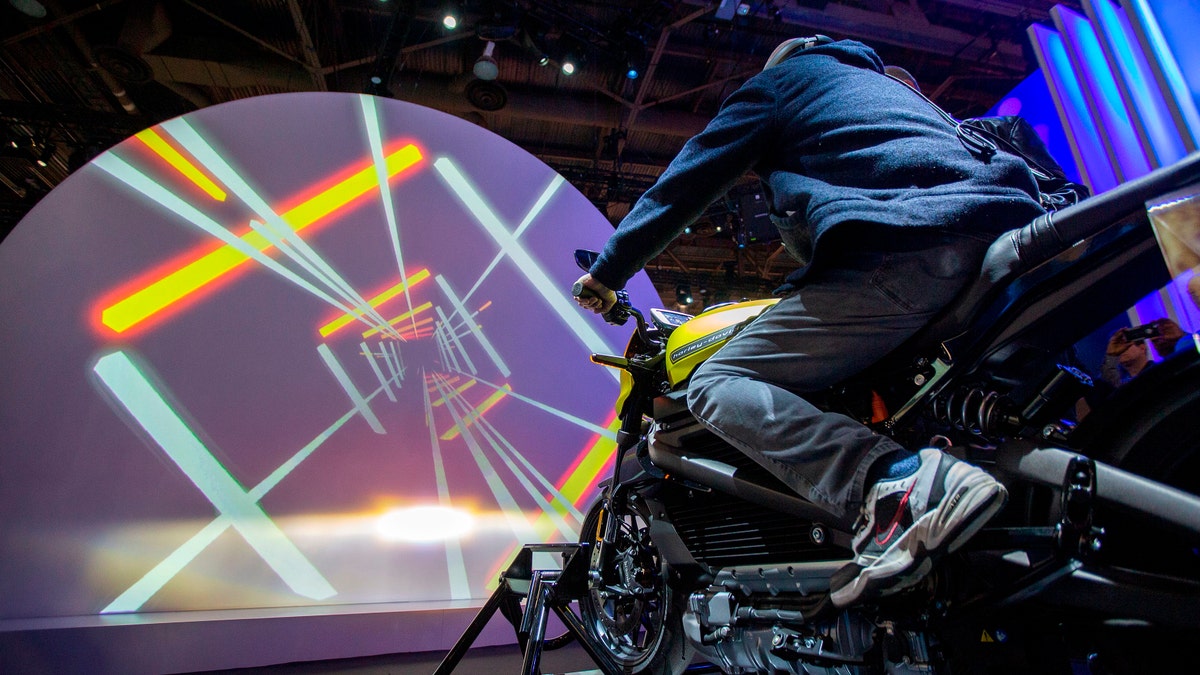 A man tries out a Harley-Davidson LiveWire electric motorcycle at the Panasonic exhibit during CES 2019 in Las Vegas, Nevada on Jan. 8, 2019.