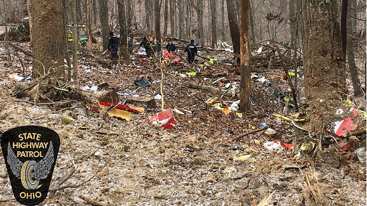 In this photo provided by the Ohio State Highway Patrol, authorities survey the scene of wreckage where a medical helicopter crashed in a remote wooded area in Brown Township, Ohio, on Tuesday on its way to pick up a patient. (Ohio State Highway Patrol via AP)