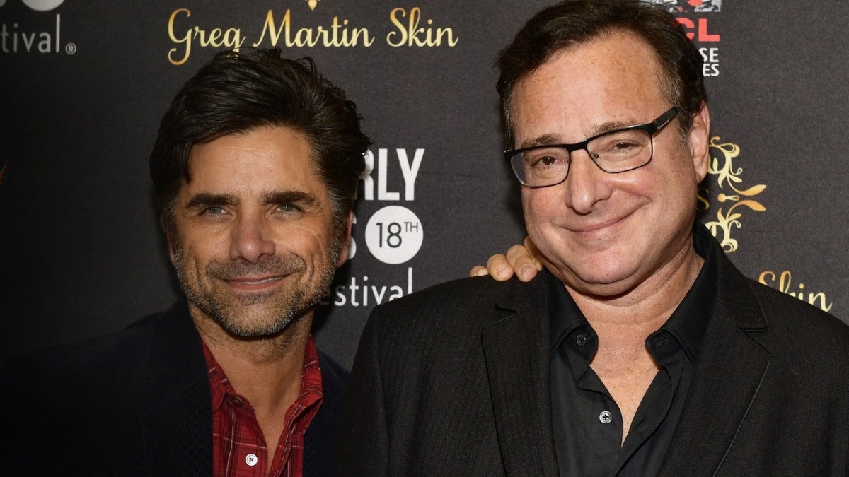 Bob Saget and John Stamos pose for a photo