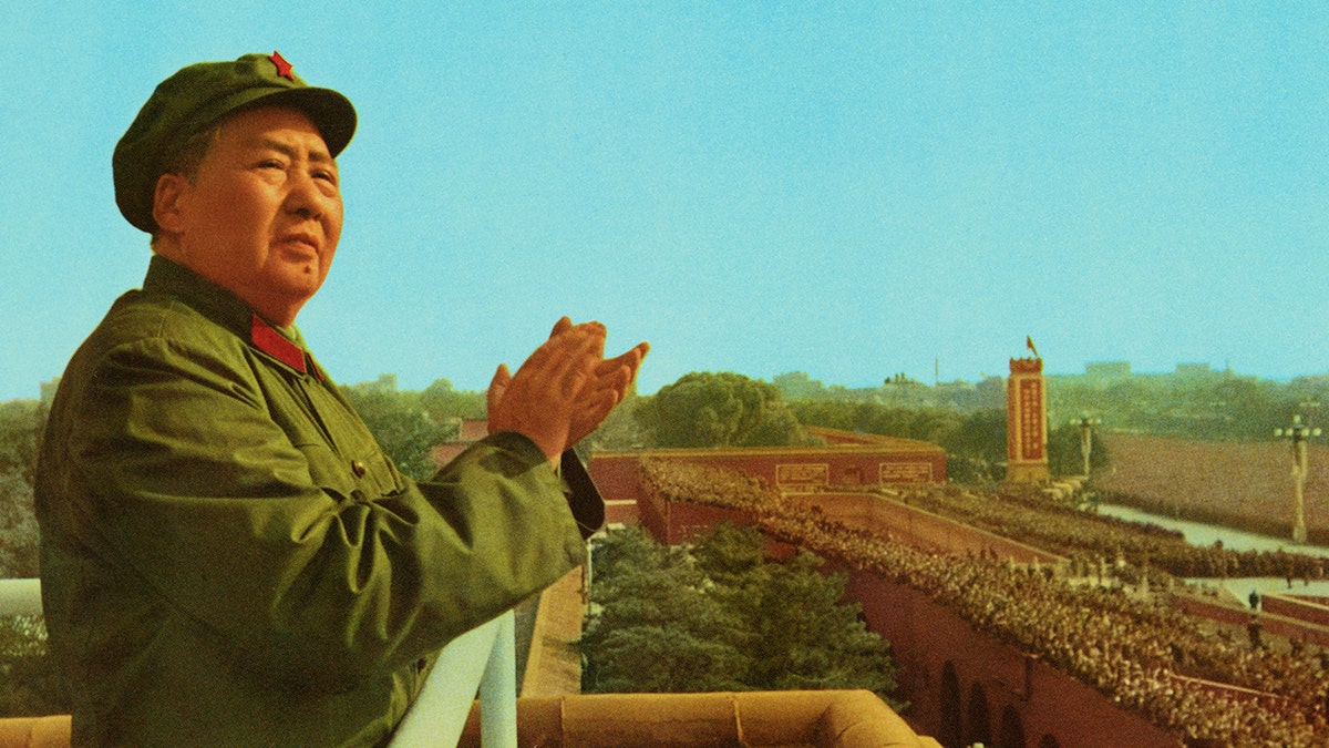 Peking, China: General view of Mao Zedong, the late Chinese Party Communist Chairman, applauding as he stands on a platform overlooking a crowd.