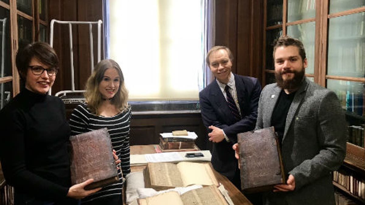 Left to right: Leah Tether, Laura Chuhan Campbell, Michael Richardson and Benjamin Pohl with the books in Bristol Central Library’s Rare Books Room