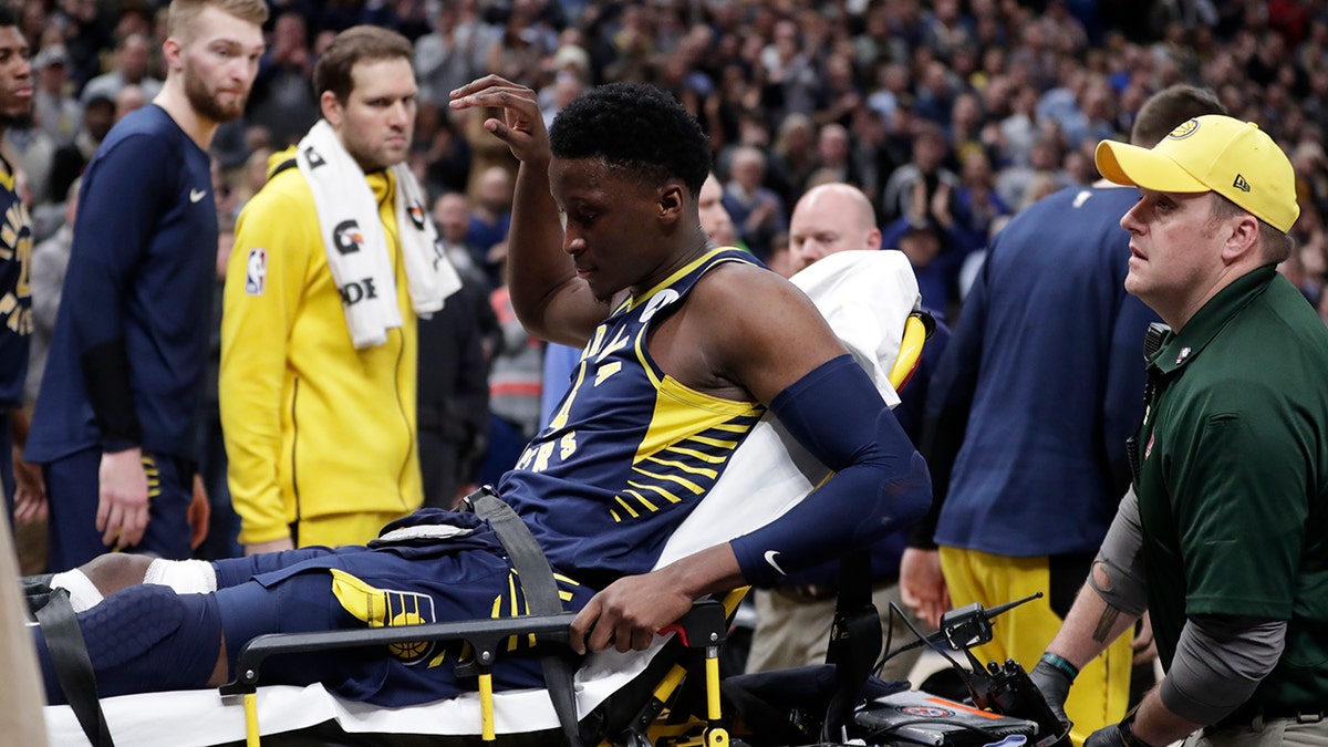 Indiana Pacers guard Victor Oladipo is taken off the court on a stretcher after he was injured during the first half of the team's NBA basketball game against the Toronto Raptors in Indianapolis, Wednesday, Jan. 23, 2019.