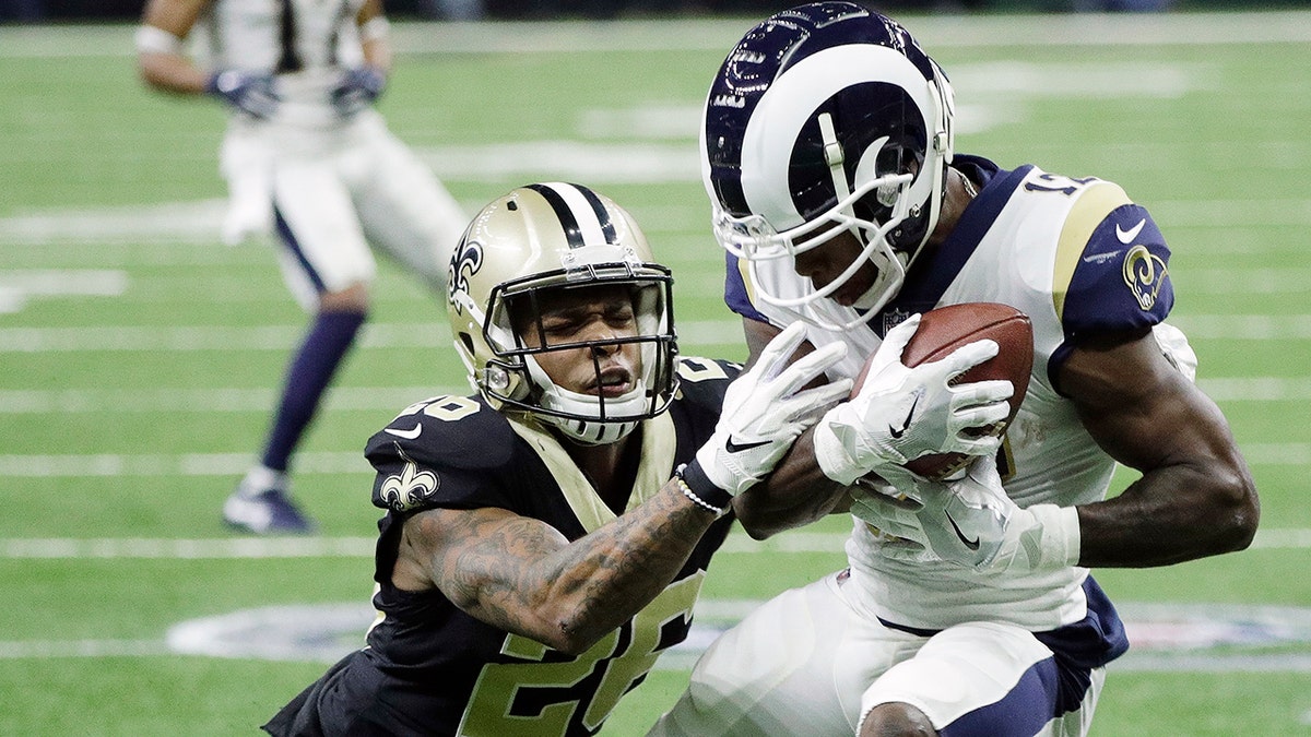 Los Angeles Rams' Brandin Cooks catches a pass in front of New Orleans Saints' P.J. Williams during the first half the NFL football NFC championship game, Sunday, Jan. 20, 2019, in New Orleans.